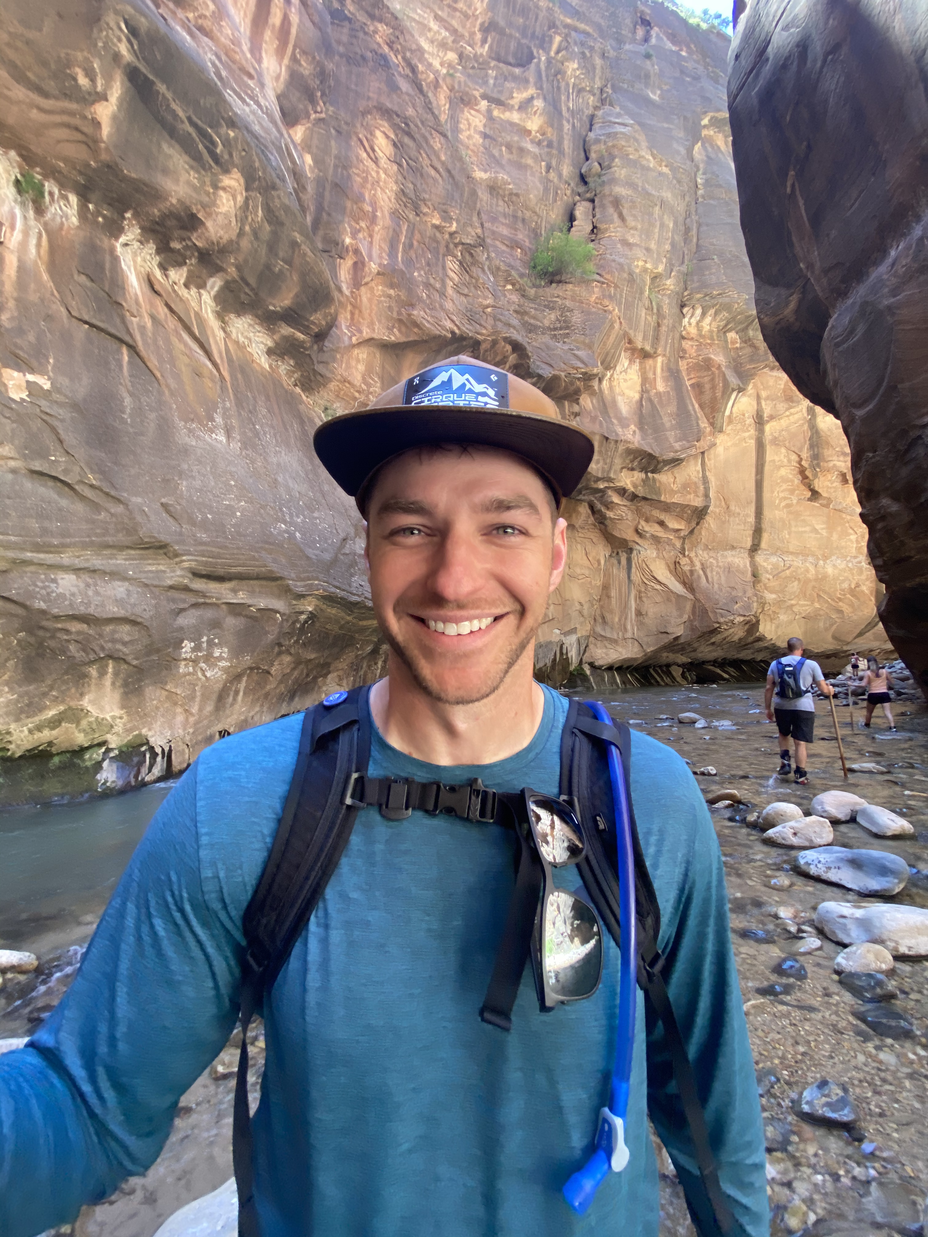 Jared Edwards smiling in front of a rock mountain